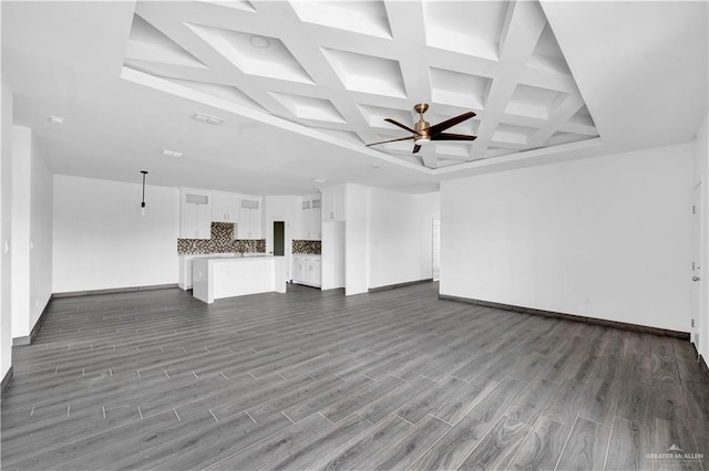 2820 Linva Ave, Mcallen, TX 78541 - unfurnished living room featuring dark wood-style floors, beam ceiling, coffered ceiling, a ceiling fan, and baseboards