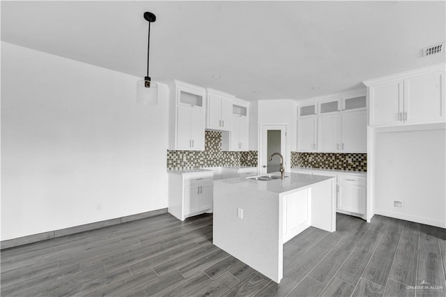 2820 Linva Ave, Mcallen, TX 78541 - kitchen with a kitchen island with sink, glass insert cabinets, a sink, white cabinetry, and visible vents