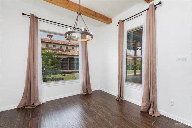 2502 Elbrus Ave, Edinburg, TX 78539 - unfurnished dining area featuring a chandelier, beam ceiling, dark wood finished floors, and baseboards