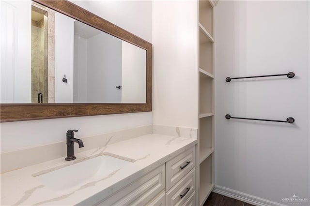 2502 Elbrus Ave, Edinburg, TX 78539 - full bathroom with vanity, baseboards, and wood finished floors