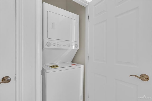 washroom featuring stacked washer and dryer