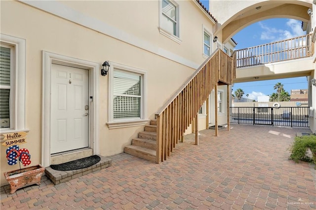 102 E Gardenia St Unit 8, South Padre Island, TX 78597 - property entrance with stucco siding and a patio