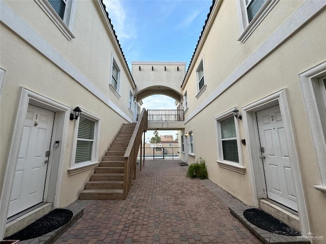 102 E Gardenia St Unit 8, South Padre Island, TX 78597 - doorway to property with stucco siding and a patio area