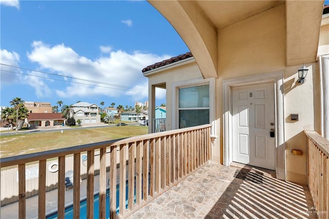 102 E Gardenia St Unit 8, South Padre Island, TX 78597 - doorway to property with a balcony, stucco siding, and a tiled roof