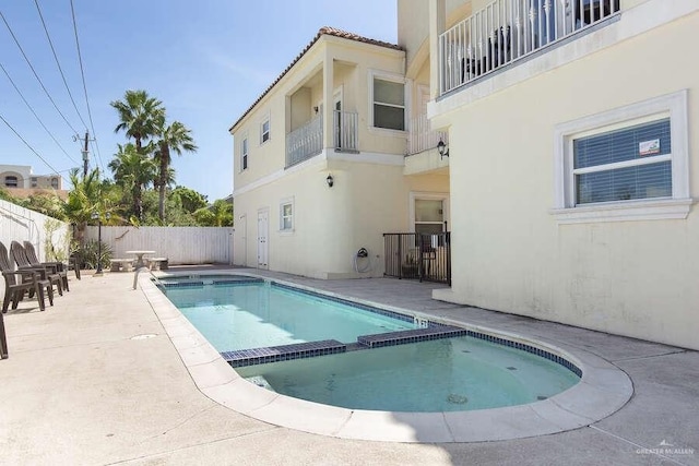 view of pool featuring a patio area and an in ground hot tub