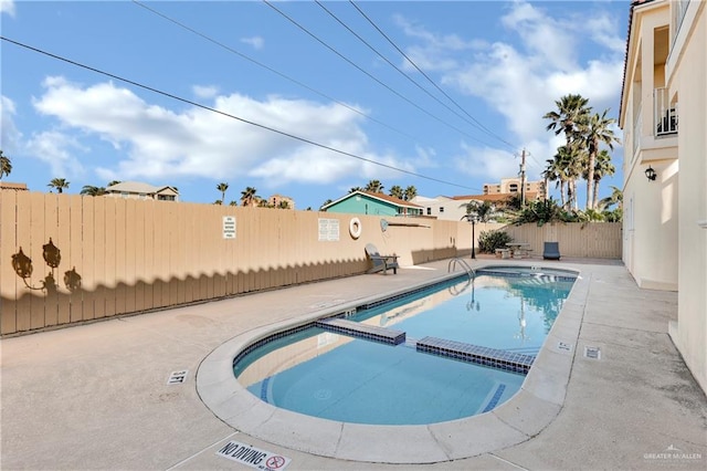 102 E Gardenia St Unit 8, South Padre Island, TX 78597 - view of pool with a fenced backyard, a pool with connected hot tub, and a patio