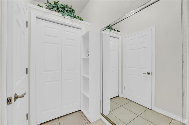 interior space with tile patterned flooring and lofted ceiling