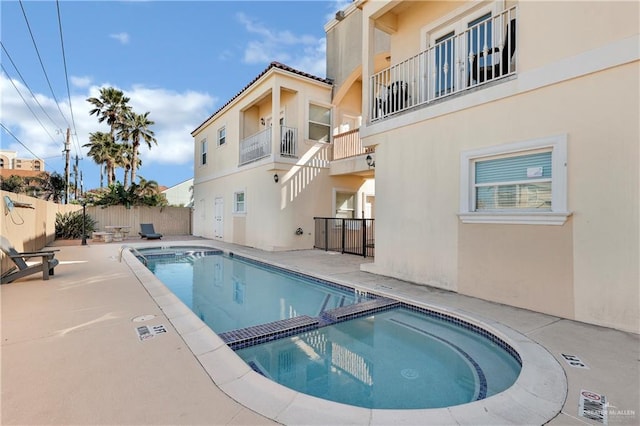 view of pool with a patio area and an in ground hot tub