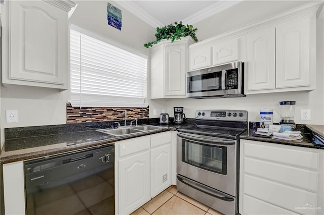 102 E Gardenia St Unit 8, South Padre Island, TX 78597 - kitchen featuring stainless steel appliances, white cabinets, crown molding, and light tile patterned floors