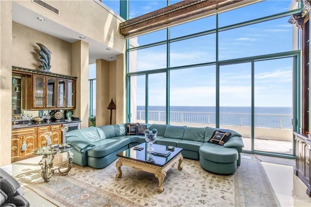310A Padre Blvd Unit 3101, South Padre Island, TX 78597 - living room with a towering ceiling, a water view, floor to ceiling windows, bar area, and tile patterned floors