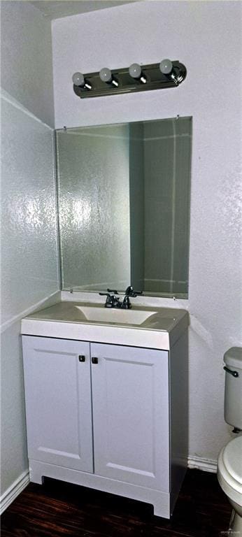 1217 S 1st St, Harlingen, TX 78550 - half bathroom with wood finished floors and vanity