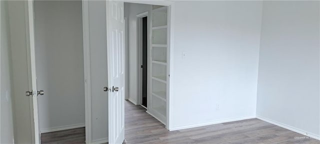 1217 S 1st St, Harlingen, TX 78550 - hall featuring wood finished floors and baseboards