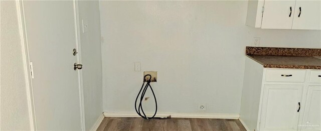 1217 S 1st St, Harlingen, TX 78550 - laundry view of baseboards and wood finished floors
