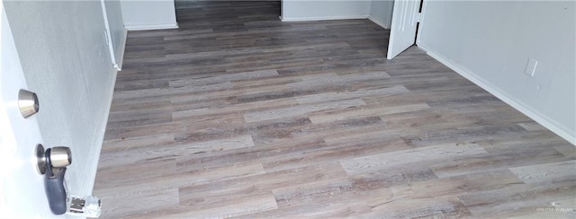 1217 S 1st St, Harlingen, TX 78550 - detailed view of wood finished floors and baseboards