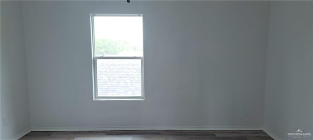 1217 S 1st St, Harlingen, TX 78550 - spare room featuring wood finished floors and baseboards