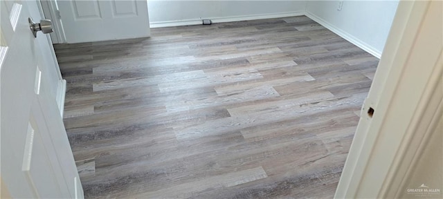 1217 S 1st St, Harlingen, TX 78550 - detailed view of wood finished floors and baseboards