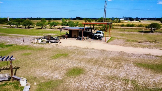 view of yard featuring a rural view and a carport