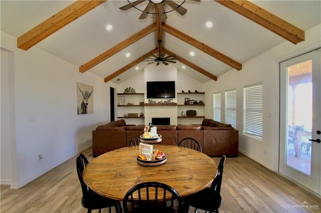 dining room with vaulted ceiling with beams, light hardwood / wood-style floors, and ceiling fan