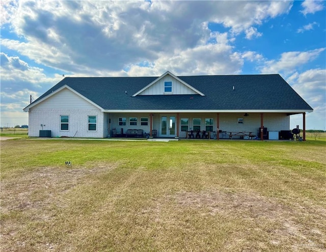 back of house with central AC, a yard, and a patio