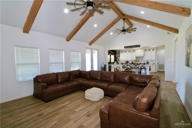 living room with ceiling fan, french doors, beamed ceiling, high vaulted ceiling, and hardwood / wood-style flooring