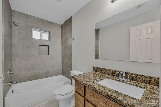 full bathroom featuring tile patterned flooring, vanity, tiled shower / bath combo, and toilet