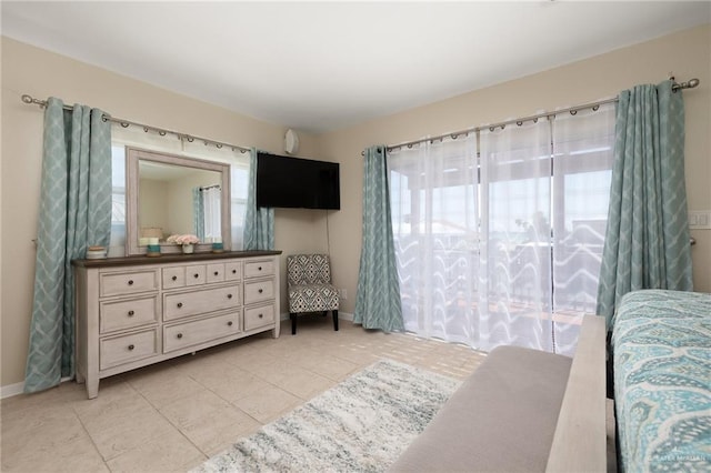 tiled bedroom featuring multiple windows