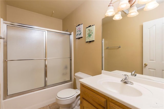 full bathroom featuring tile patterned flooring, vanity, toilet, and shower / bath combination with glass door