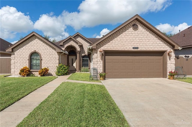 view of front of home with a garage and a front lawn