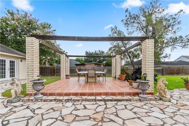 3206 Marion Ct, Harlingen, TX 78550 - fenced backyard with french doors, a patio, and outdoor dining space