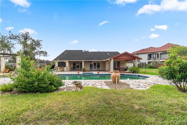 3206 Marion Ct, Harlingen, TX 78550 - rear view of house featuring a patio area, an outdoor pool, and a lawn