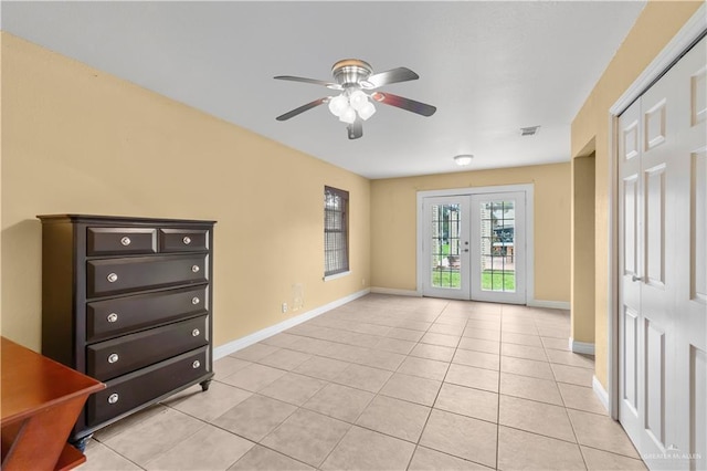 3206 Marion Ct, Harlingen, TX 78550 - empty room with ceiling fan, french doors, and light tile patterned floors
