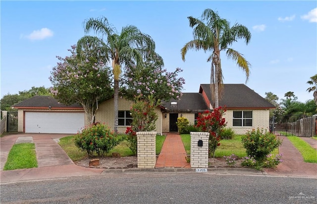 3206 Marion Ct, Harlingen, TX 78550 - view of front of property with driveway, brick siding, and a garage