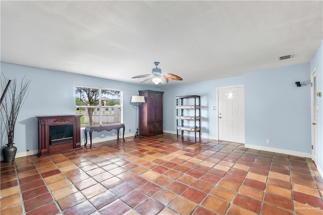 3206 Marion Ct, Harlingen, TX 78550 - unfurnished living room featuring ceiling fan, tile patterned flooring, and a fireplace