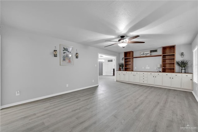 1702 Elmwood Dr, Harlingen, TX 78550 - unfurnished living room featuring baseboards, ceiling fan, and light wood-type flooring