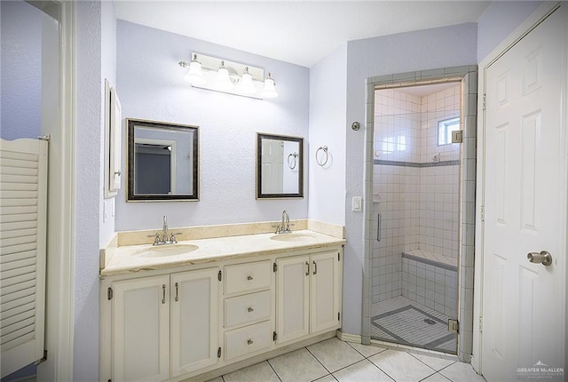 bathroom featuring an enclosed shower, vanity, and tile patterned floors