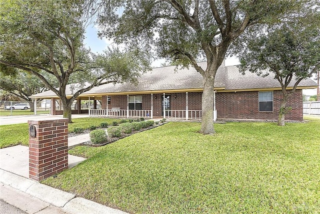 ranch-style house featuring a front lawn and covered porch