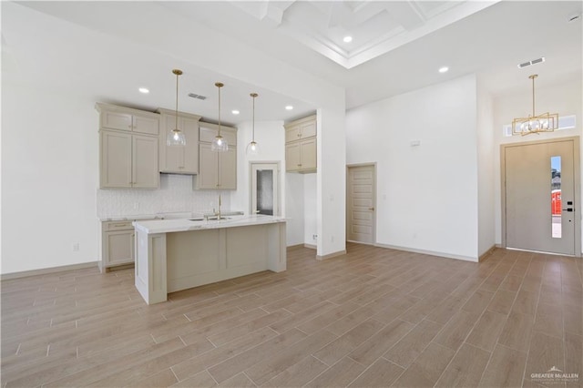905 E 38th St E, San Juan, TX 78589 - kitchen with recessed lighting, decorative backsplash, light wood finished floors, a sink, and light countertops