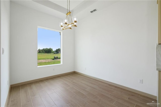 905 E 38th St E, San Juan, TX 78589 - spare room with a chandelier, wood finished floors, and baseboards