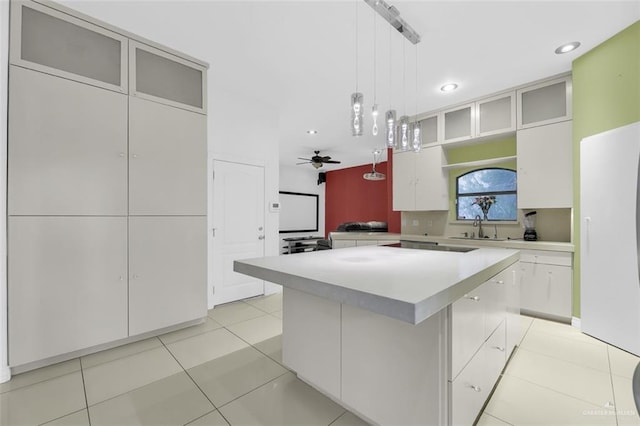 kitchen featuring a sink, light countertops, pendant lighting, and recessed lighting