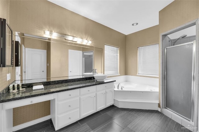 full bath featuring a stall shower, vanity, a bath, and tile patterned flooring