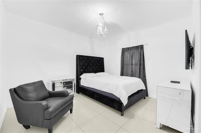 bedroom featuring baseboards, a notable chandelier, and light tile patterned floors