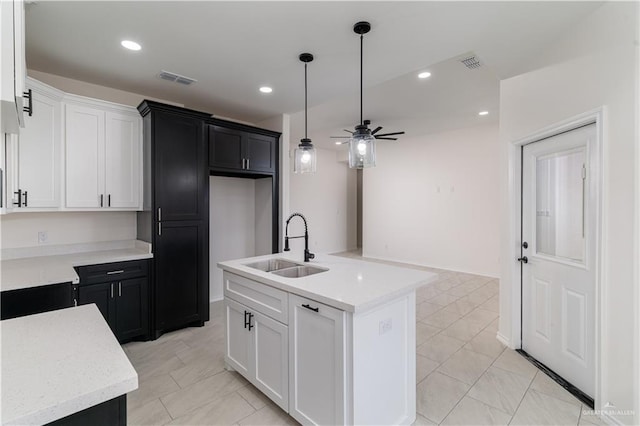328 N Leon Ave, Elsa, TX 78543 - kitchen with a sink, a ceiling fan, pendant lighting, dark cabinetry, and recessed lighting