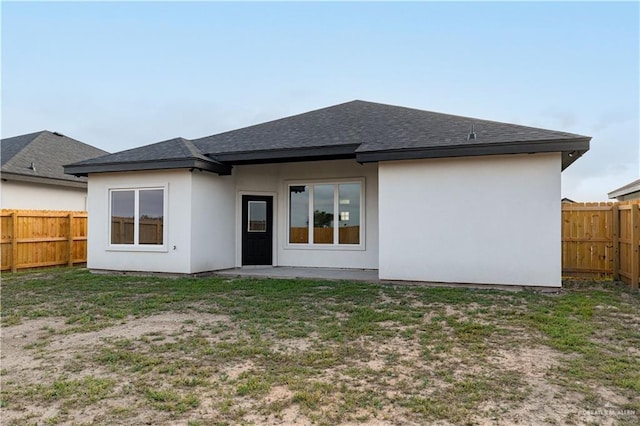 328 N Leon Ave, Elsa, TX 78543 - back of house with roof with shingles and stucco siding