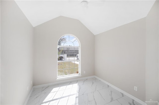 empty room featuring ceiling fan and lofted ceiling