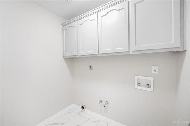 clothes washing area with gas dryer hookup, cabinets, hookup for an electric dryer, and hookup for a washing machine