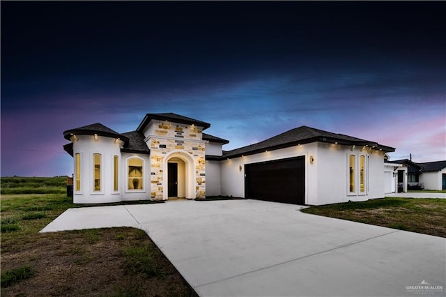 mediterranean / spanish-style home featuring a garage and a lawn