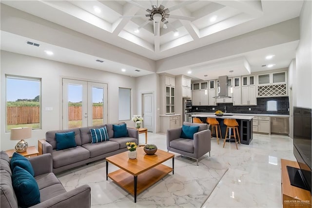 living room featuring ceiling fan, french doors, beamed ceiling, and coffered ceiling