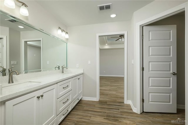 bathroom with a sink, visible vents, and wood finished floors