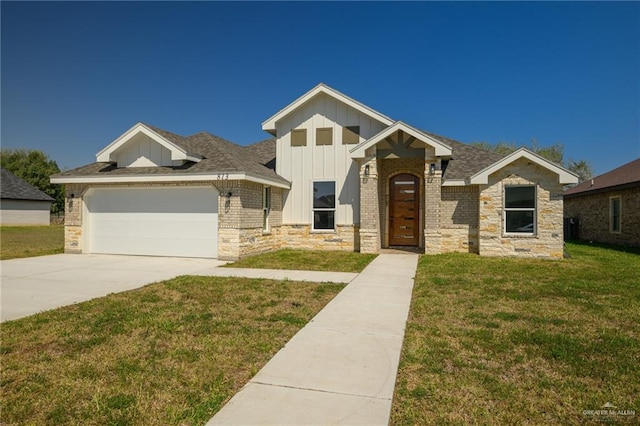 view of front of property with brick siding, board and batten siding, a front lawn, concrete driveway, and a garage