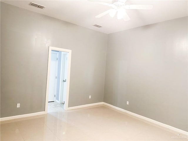 tiled empty room featuring ceiling fan